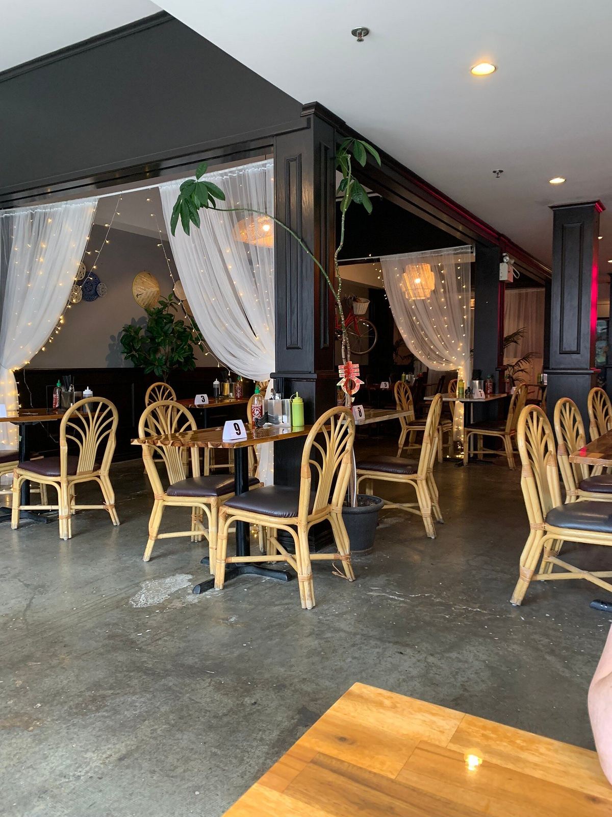 Front dining room with rattan chairs and sheer curtains
