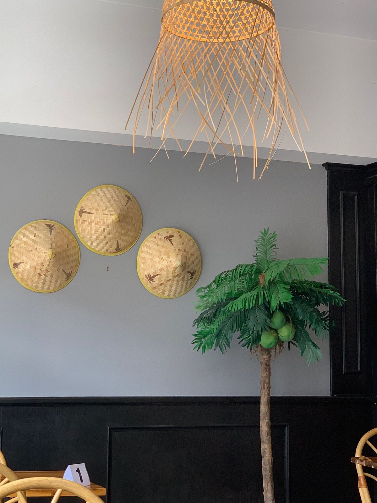 Conical hats and a palm tree on the dining room wall